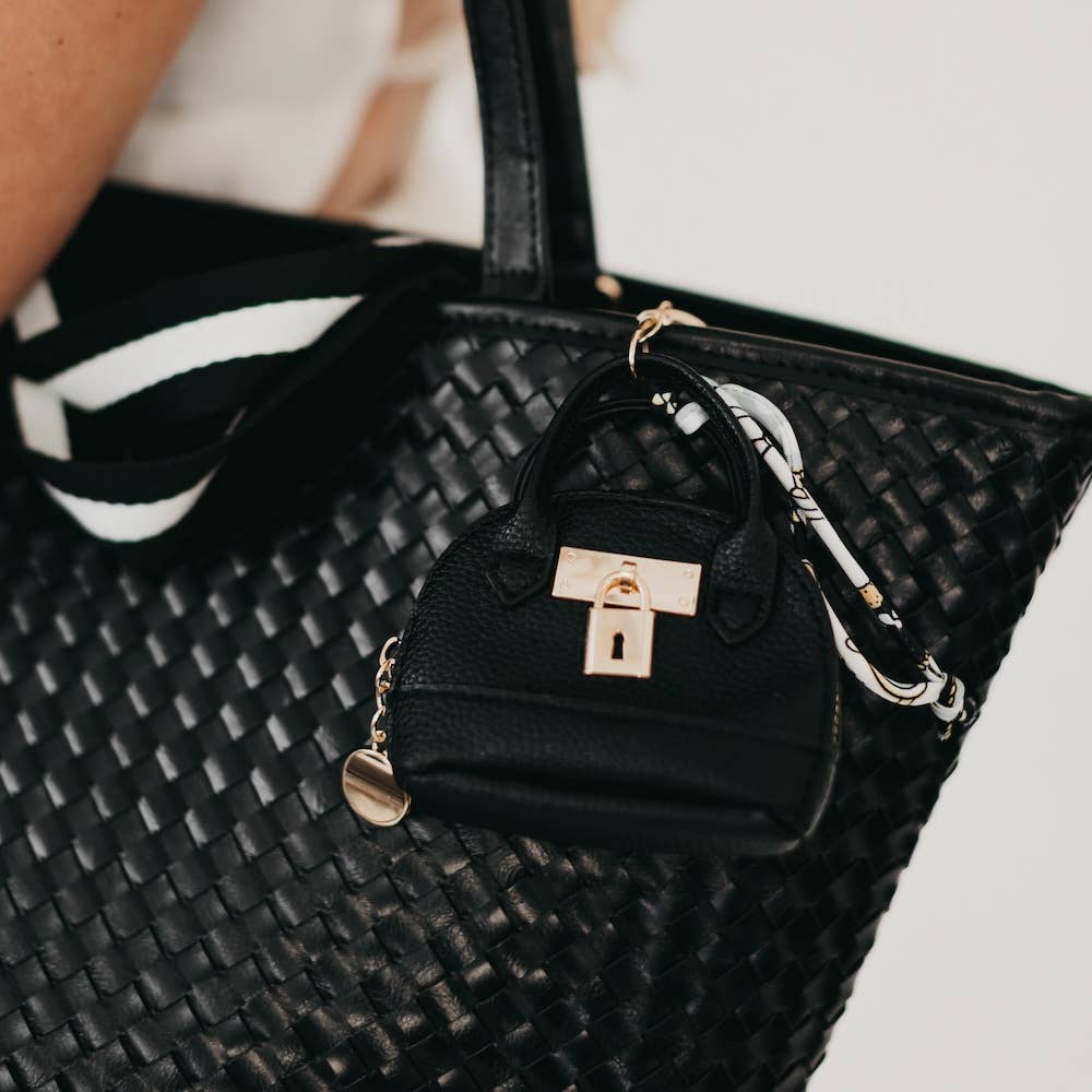 Small black handbag with a gold lock detail