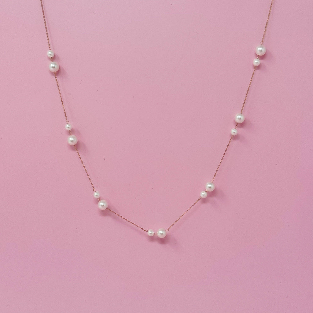 Pearl necklace on a pink background