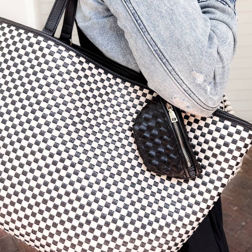 Black and white checkered bag with a black mini charm pouch