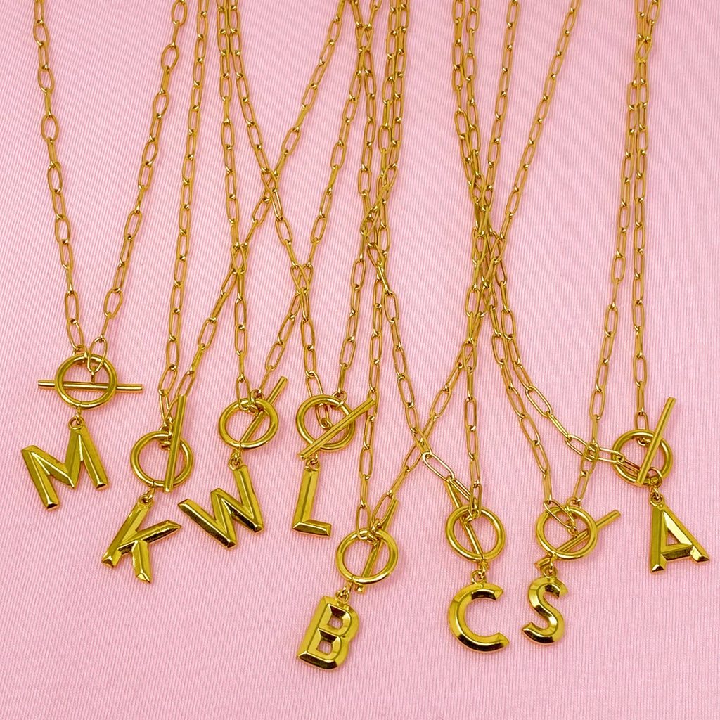 Gold necklaces with letter pendants 