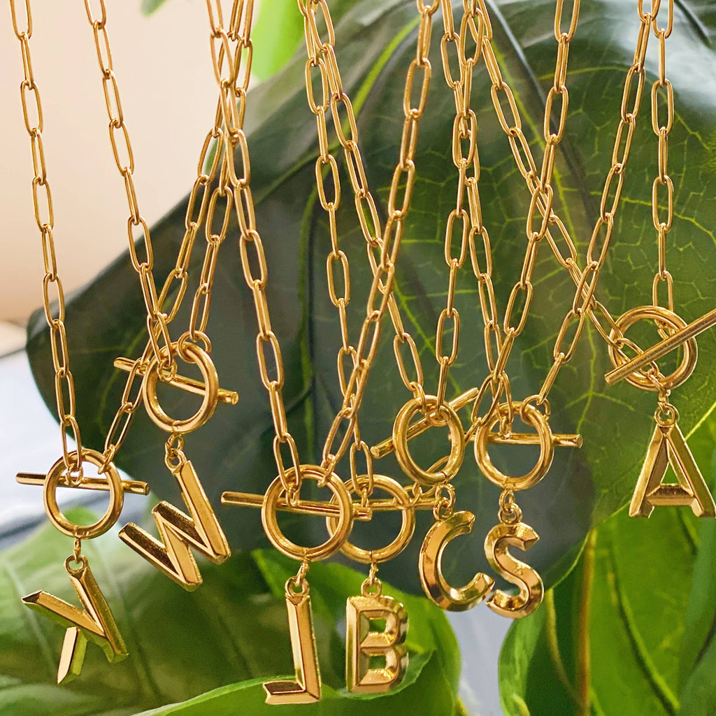 Gold necklaces with letter pendants