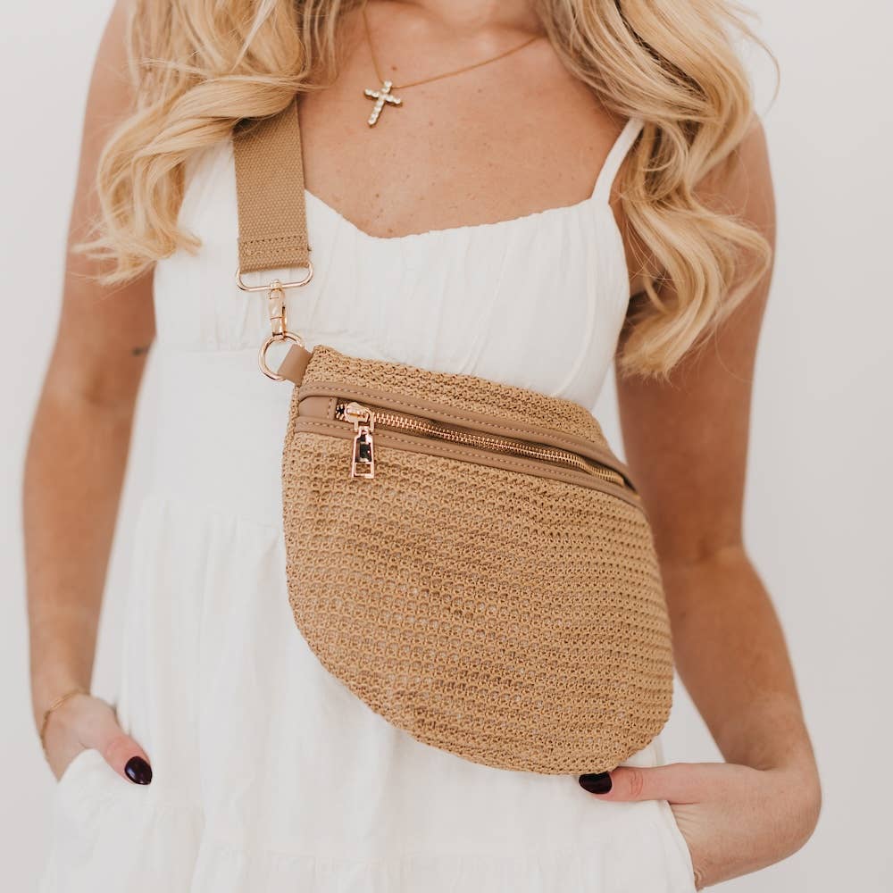 Brown raffia bum bag with a gold zipper and adjustable strap.