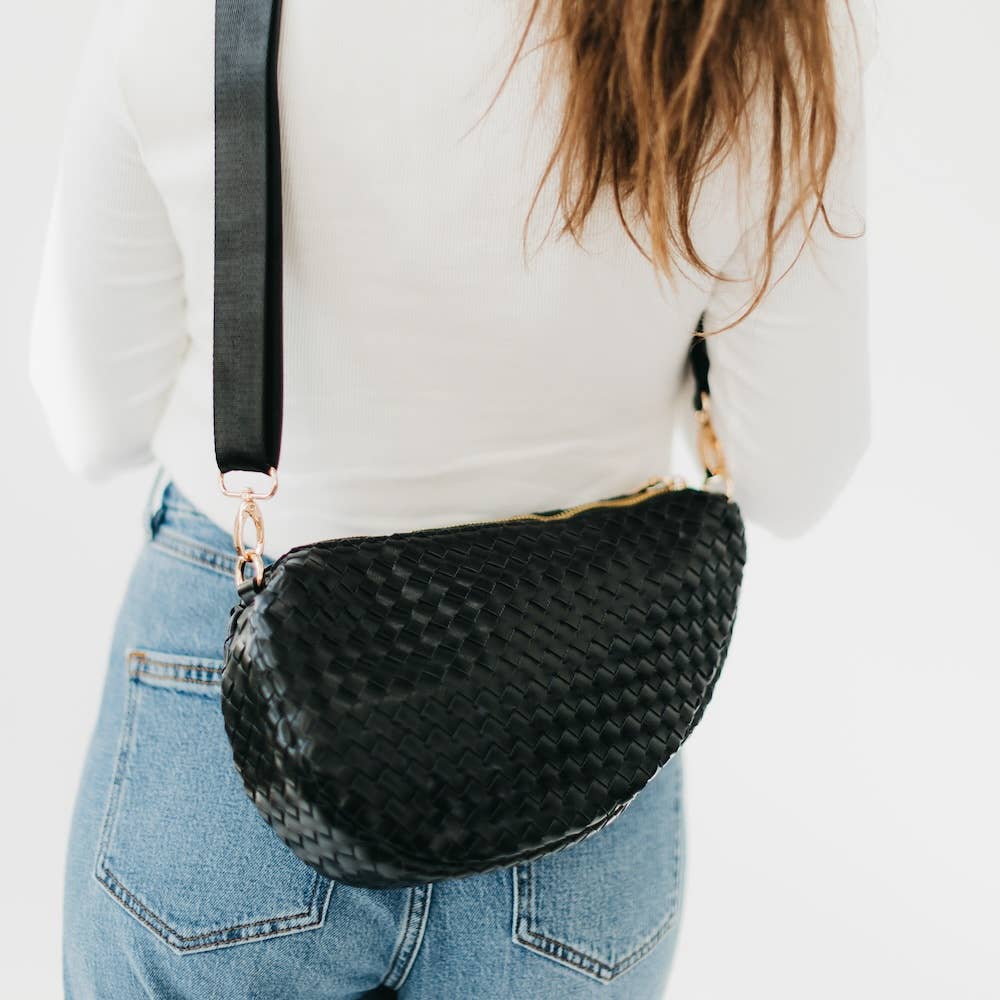 Person wearing a black woven bag
