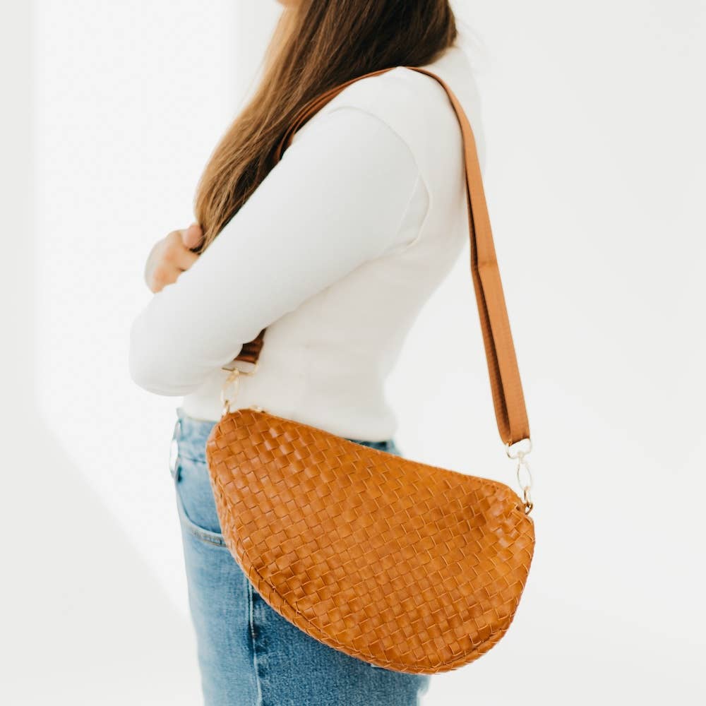 Person wearing a brown woven handbag 