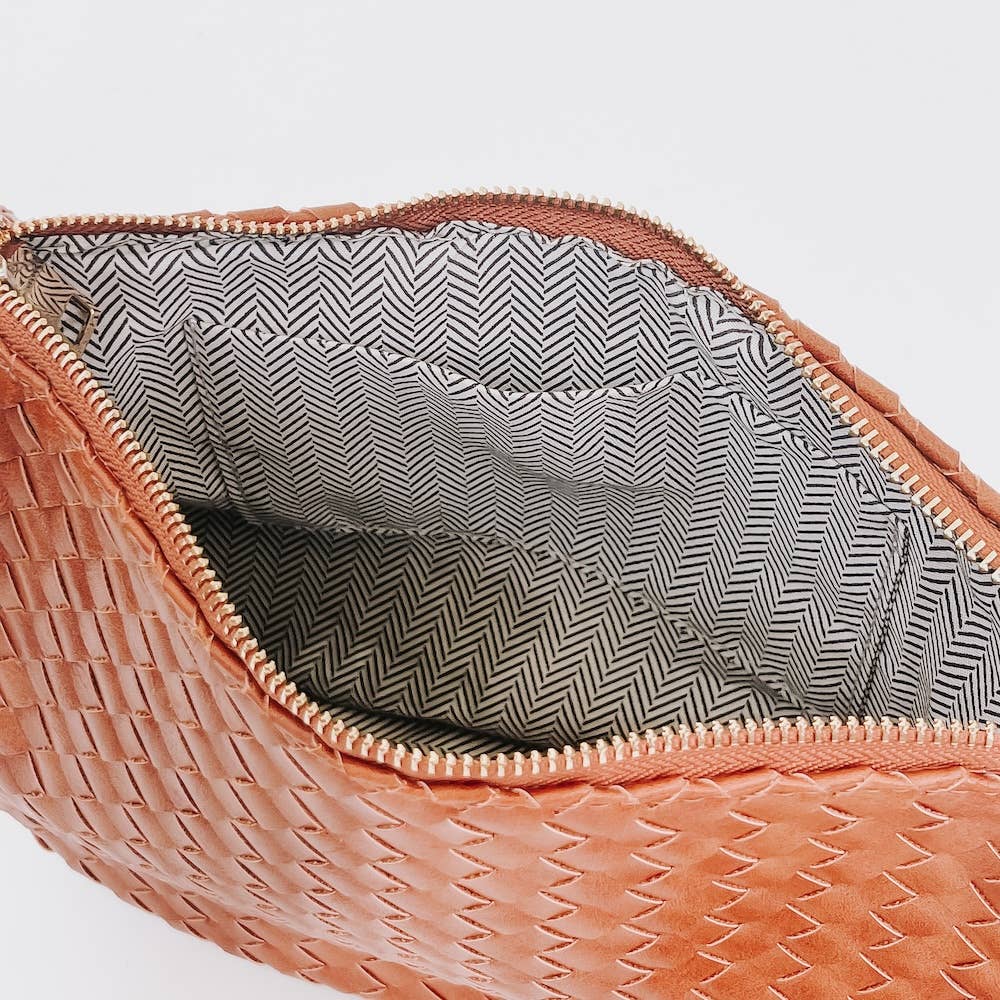 Close-up of a brown woven bag with a patterned interior 